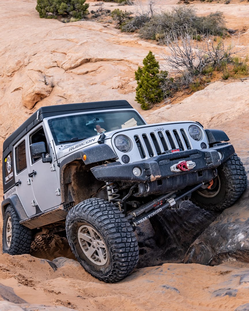 Jeep Camper climbing an obstacle in Moab Utah